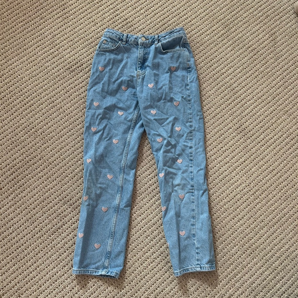 Women’s blue jeans with pink heart pattern